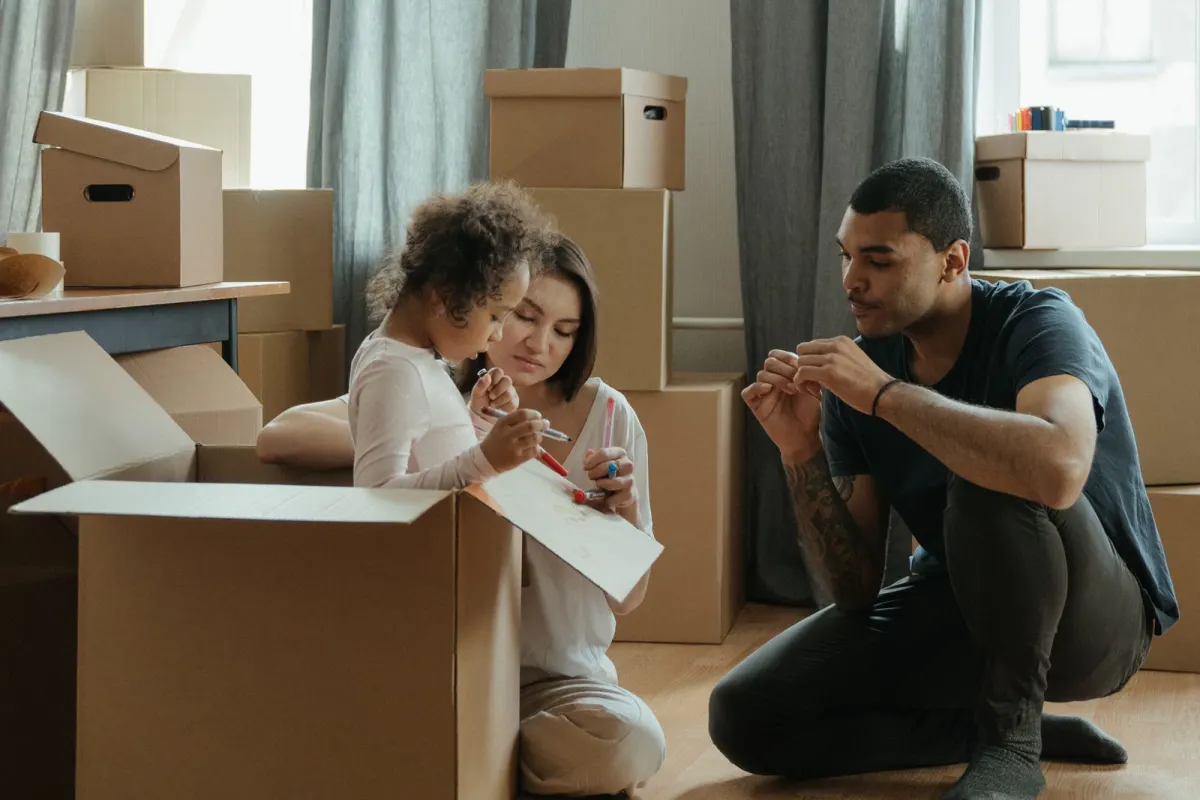 Family unpacking cartons in their new home
