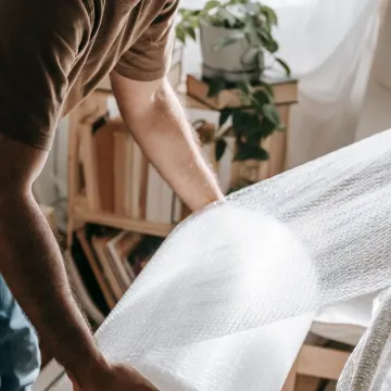 Furniture being wrapped in bubble wrap before a home move