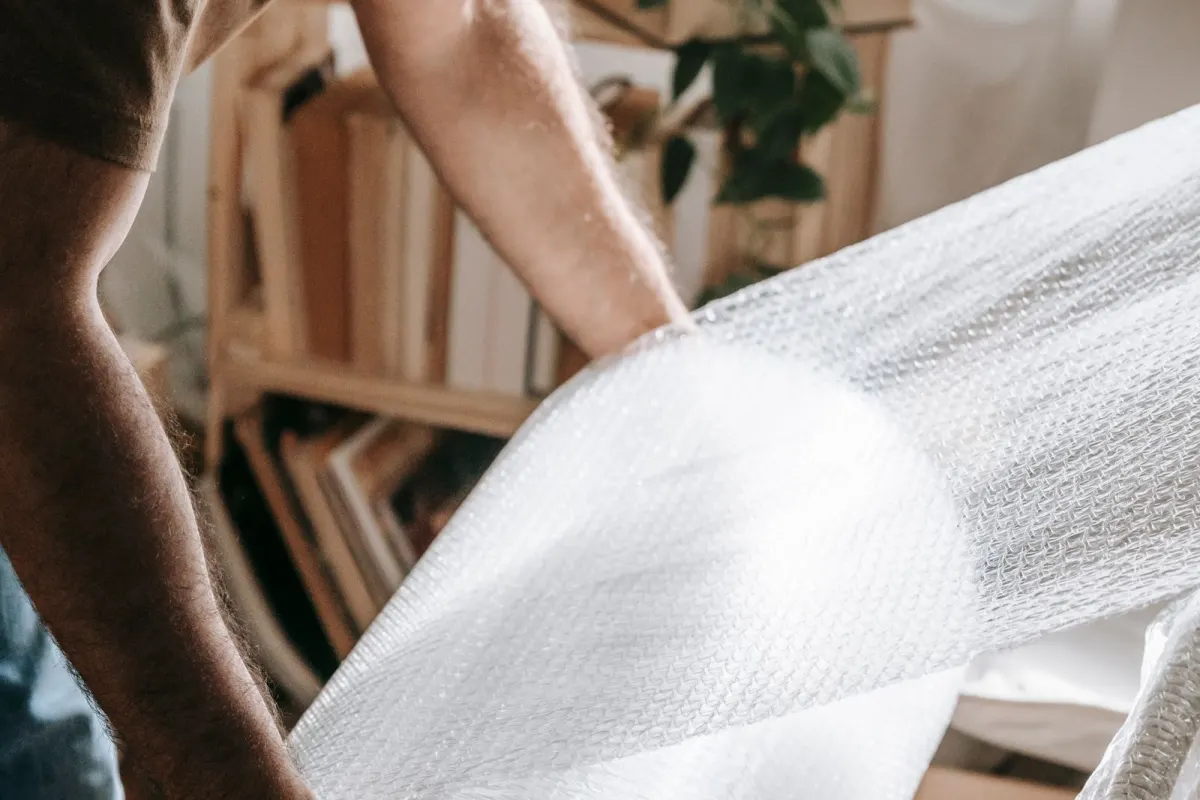Furniture being wrapped in bubble wrap before a home move