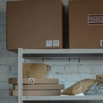 Packed cartons on steel shelves in a storage warehouse